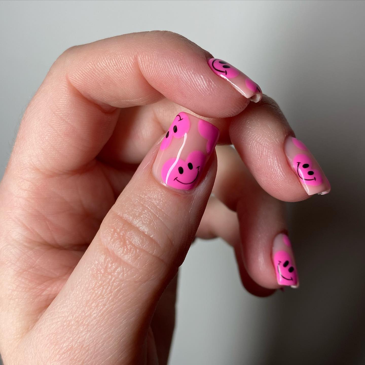 43. Smile-inducing Bliss: the Pink Heart and Happy Face Nail Art