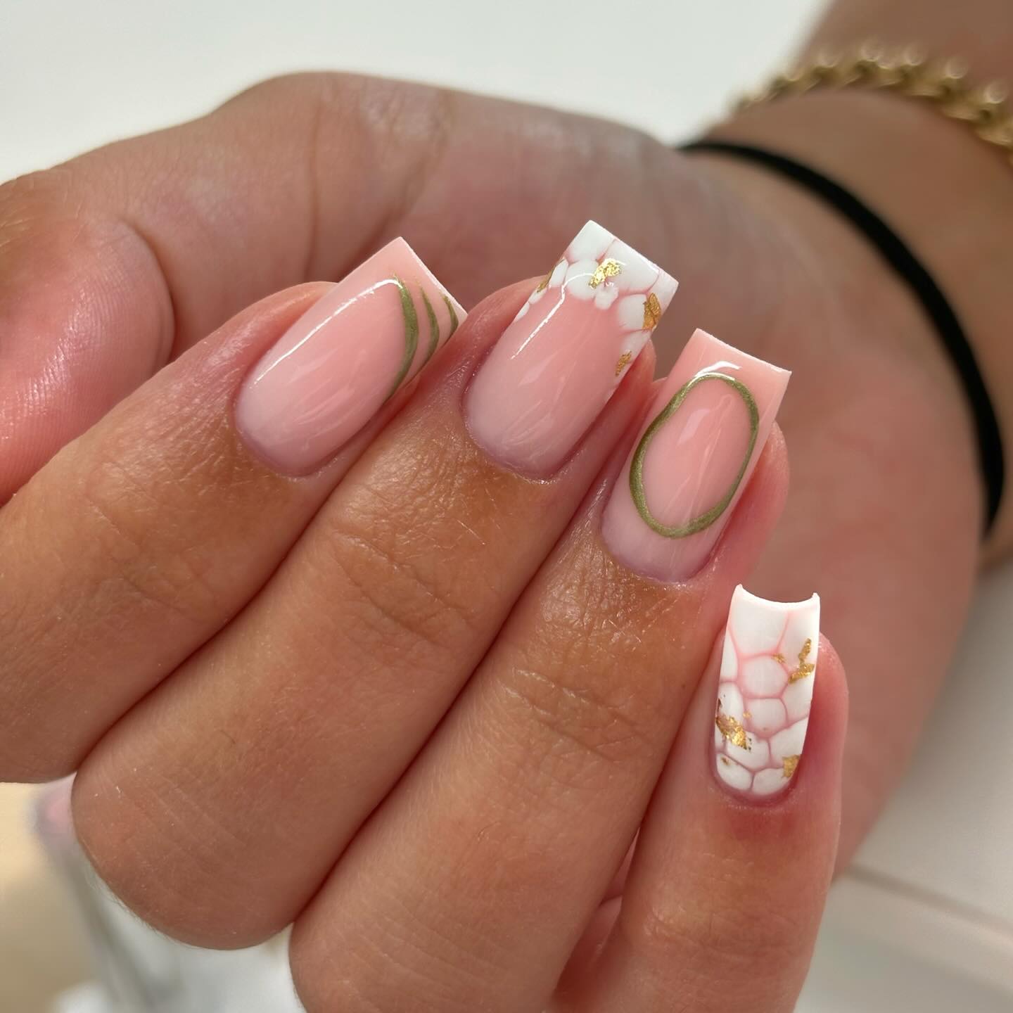 16. Botanical Elegance: a Chic Twist on French Tips with Floral Graphique