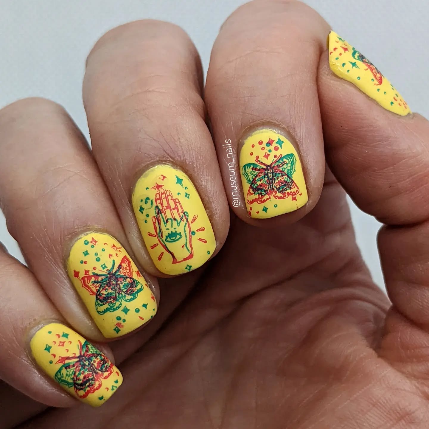24. Kaleidoscope Dreams: Whimsical Yellow Nails with Mystical Motifs