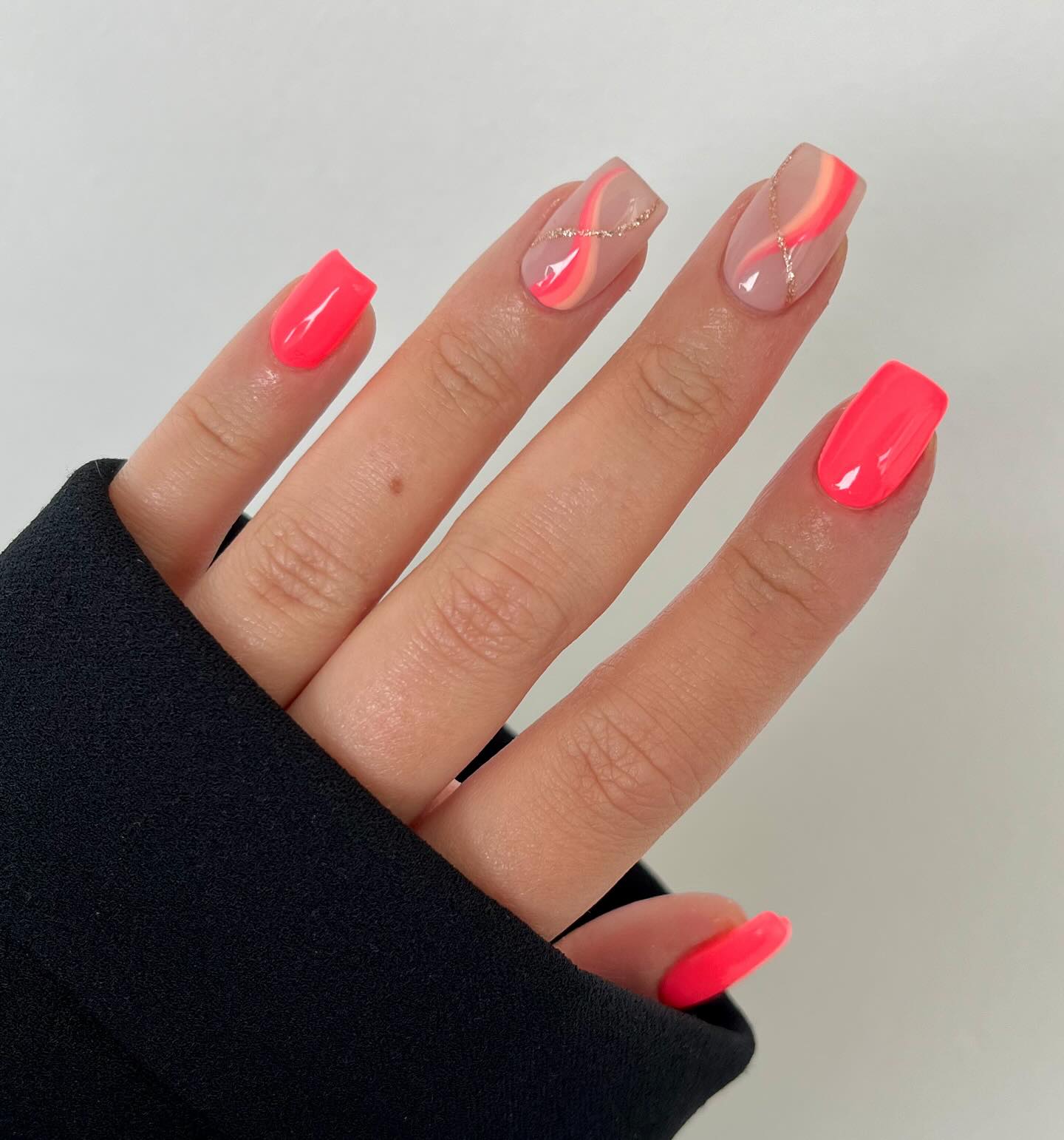 11. Radiant Coral Waves with Glamorous Gold Accents