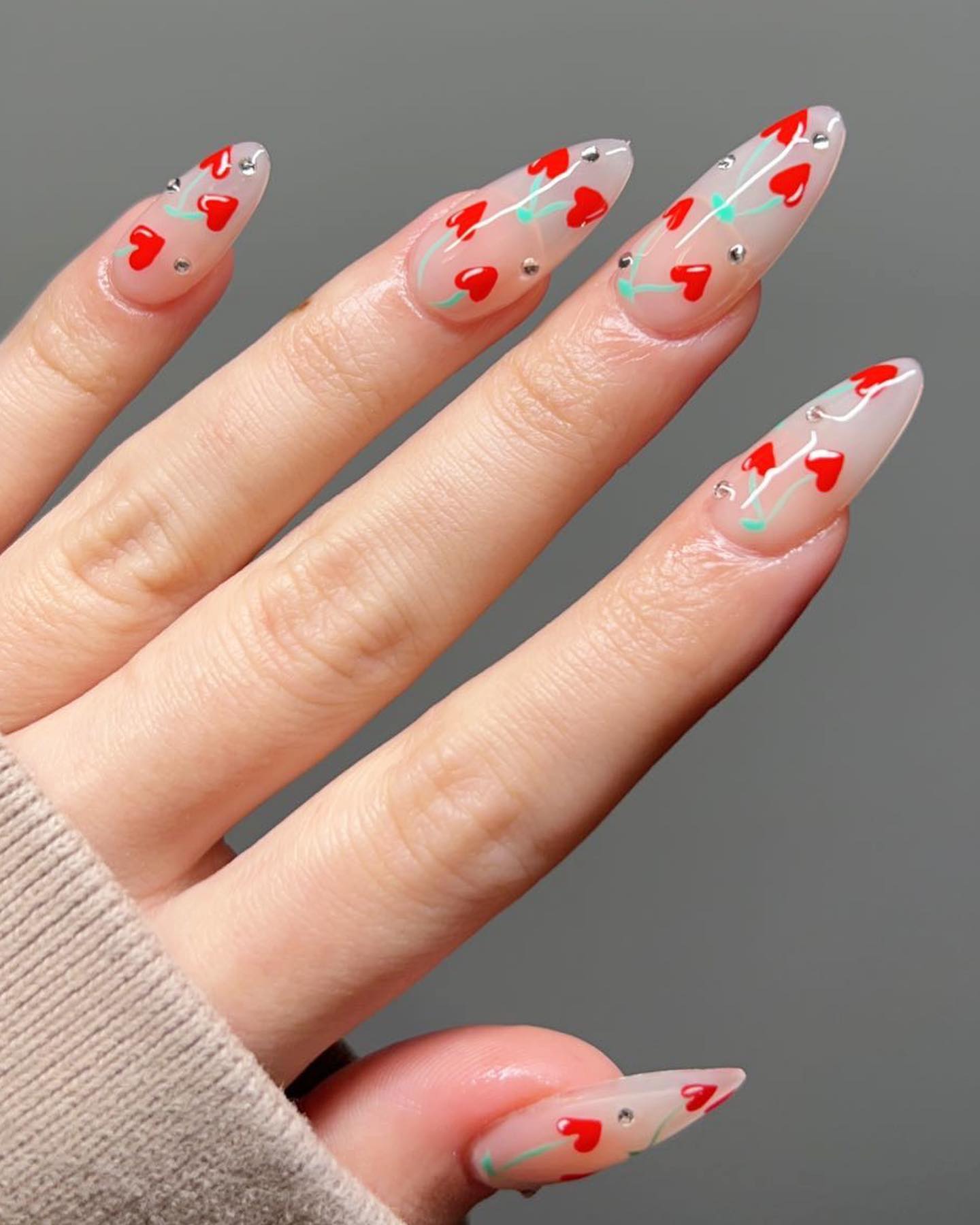 13. Heartfelt Whimsy: Playful Romance on Almond-tipped Nails