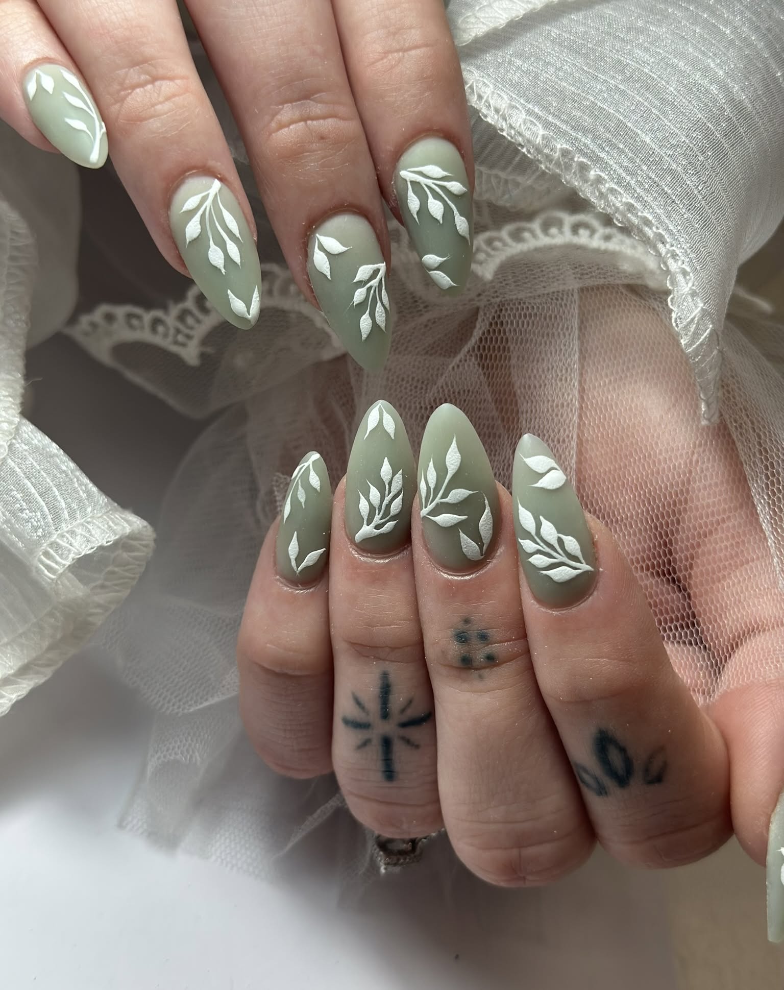 36. Whispers Of Nature: Enchanted Sage Green Manicure with Ethereal Leaf Designs